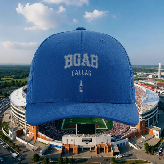 Better Grab A Beer blue six-panel trucker hat with BGAB Dallas logo and mesh back against a stadium background