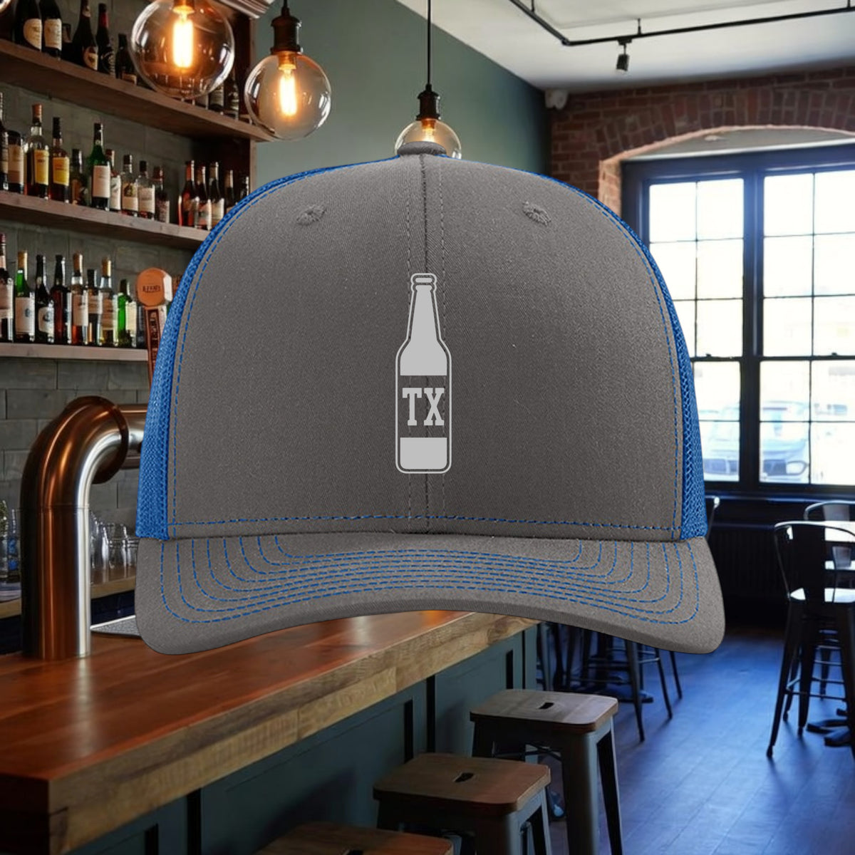 Better Grab A Beer TX Bottle trucker hat in grey with blue mesh back, contrast stitching, and snapback closure.