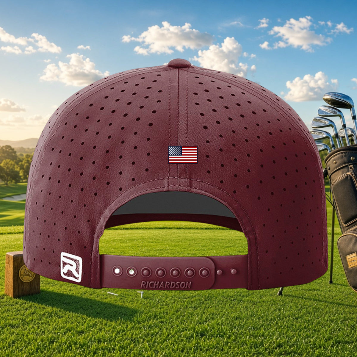 Better Grab A Beer maroon golf cap with laser-cut perforations, US flag detail, and snapback closure on a golf course.