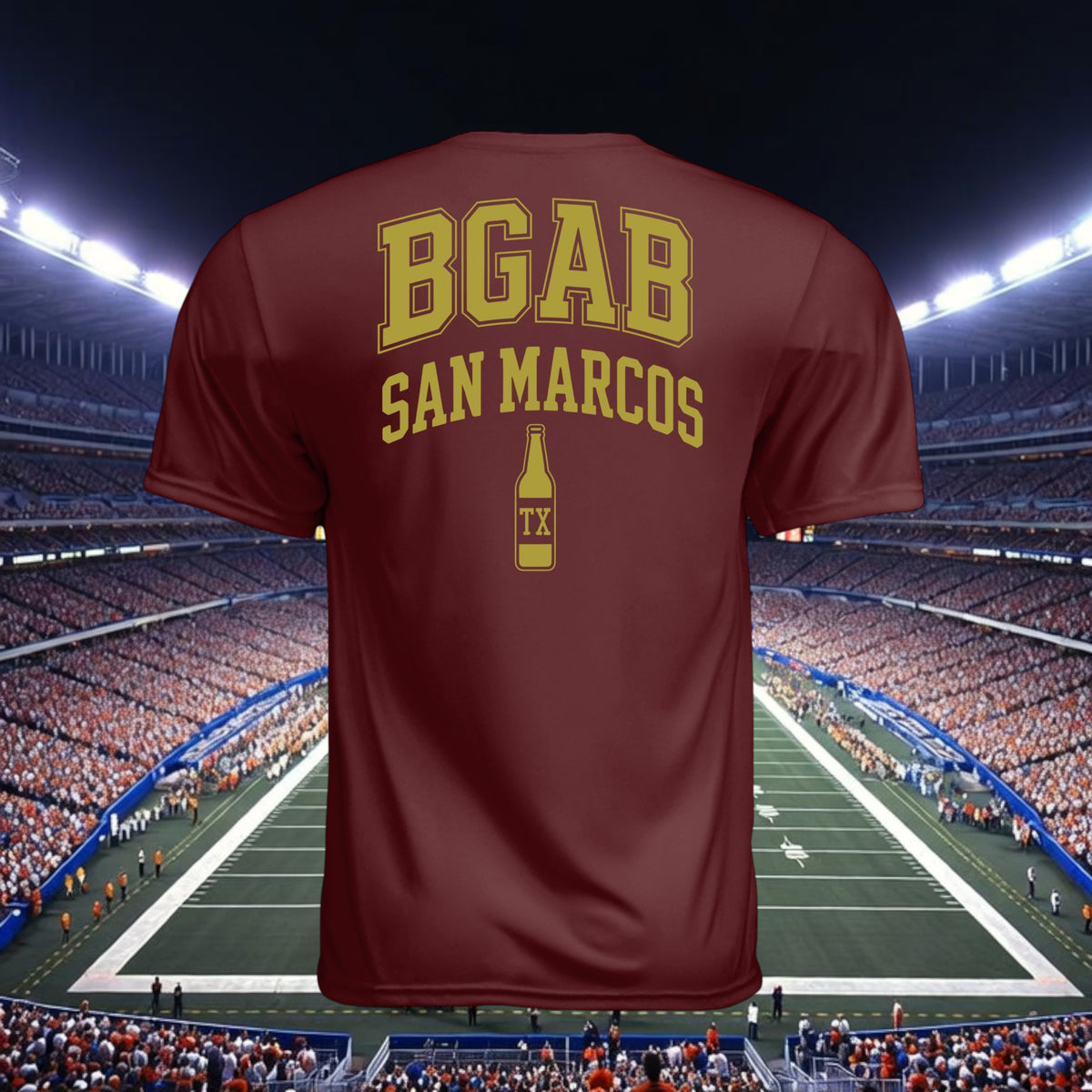 Better Grab A Beer maroon performance crew neck t-shirt with gold BGAB San Marcos logo on back against stadium background