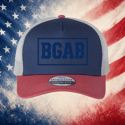 Better Grab A Beer navy and red trucker cap with BGAB logo, mesh back, and pre-curved visor on American flag background