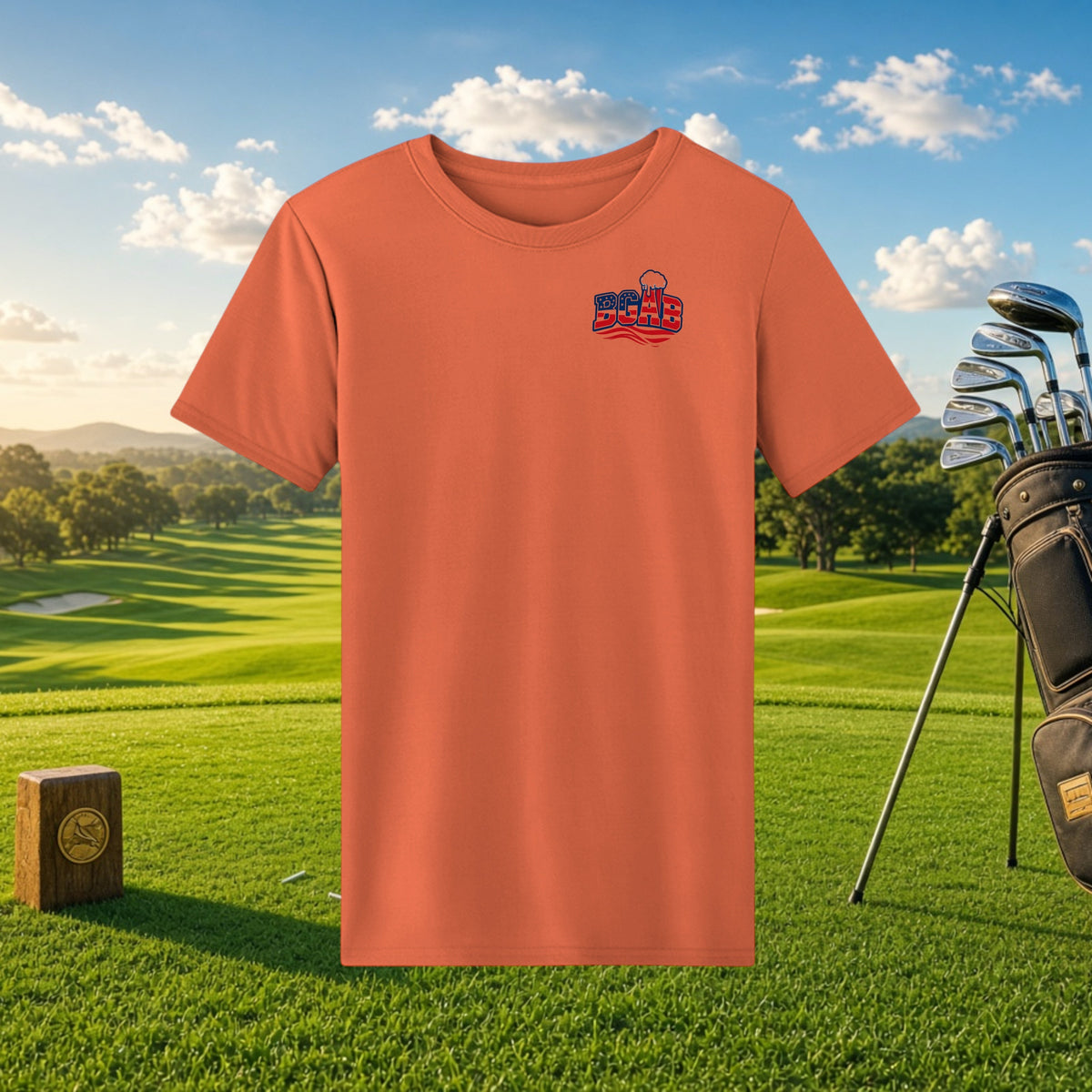 Better Grab A Beer orange performance t-shirt with BGAB logo, featuring moisture-wicking fabric on a golf course.
