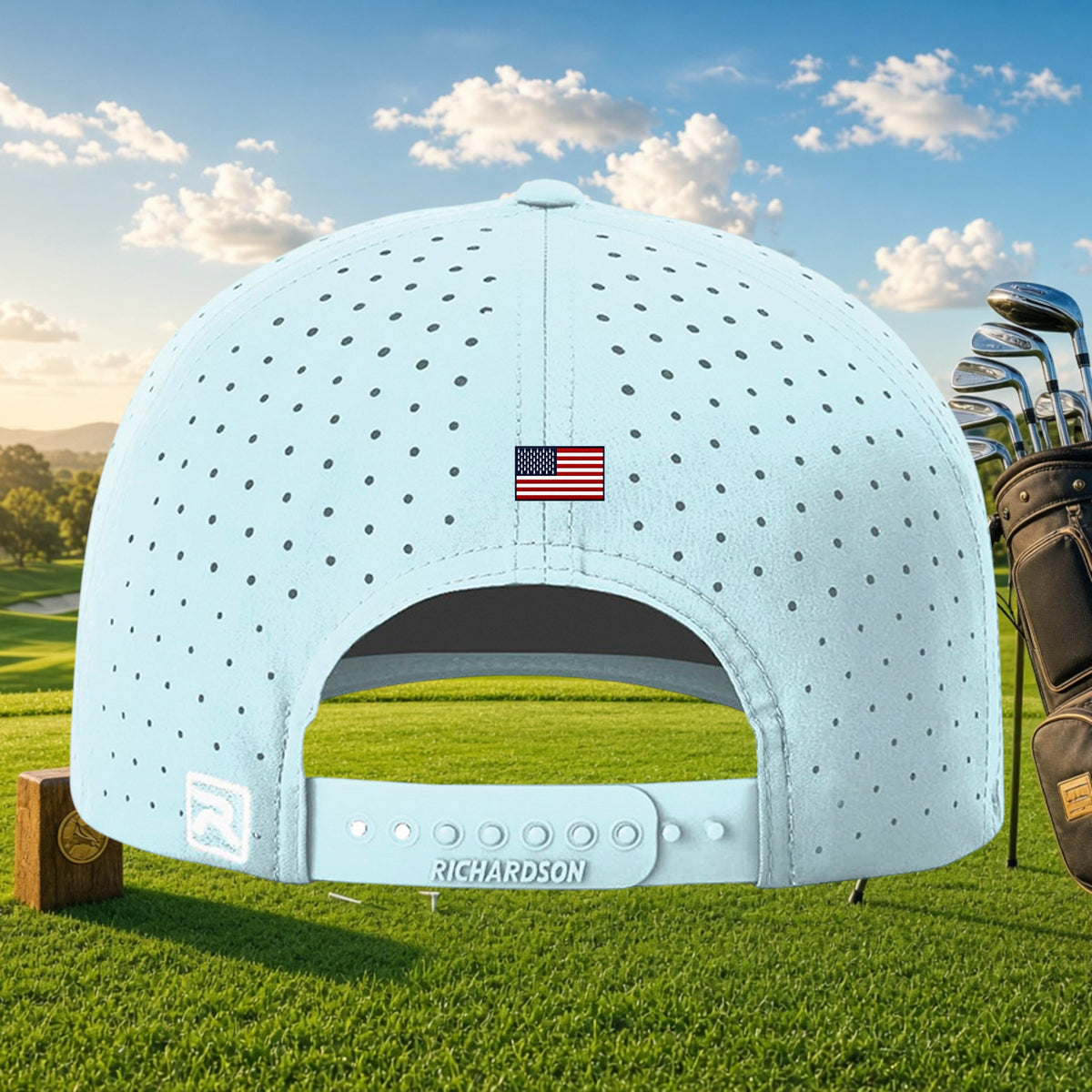 Better Grab A Beer light blue perforated golf cap with US flag detail and snapback closure on a golf course background
